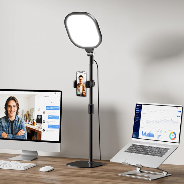 Panel de luz LED con soporte ajustable frente a una laptop en un escritorio
